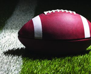 An image of a football in a football field.