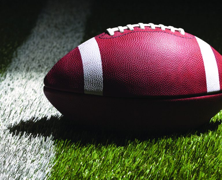 An image of a football in a football field.