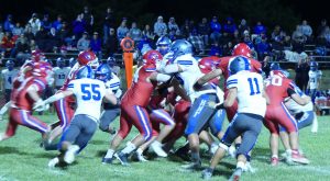 A group of football players tackle into each other