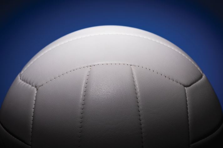 An image of a white volleyball in a blue background.