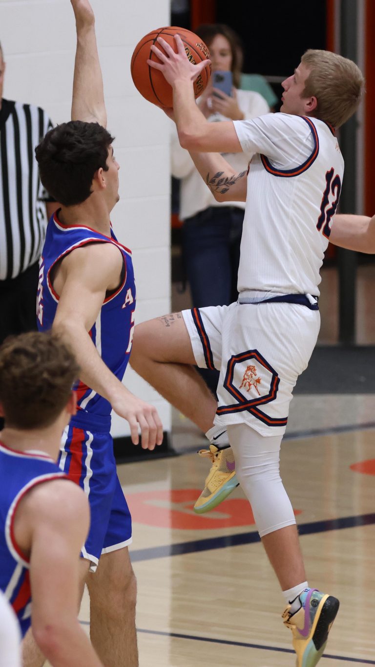 Photos by Marla Taylor/Junior Dustin Veach (#12) powers through Axtell's defense during the varsity boys' basketball game on Tuesday, Jan. 28.